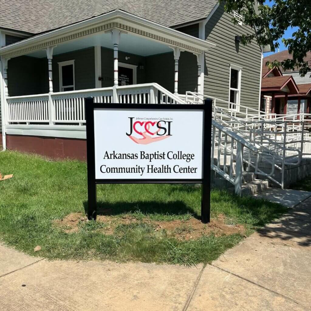 AR Baptist College exterior sign with black posts