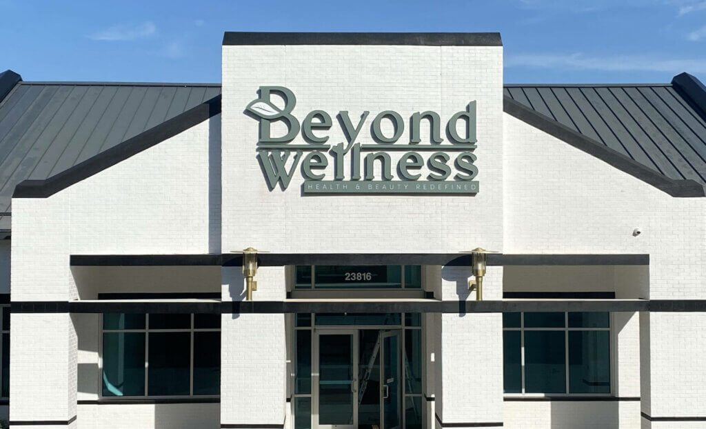 beyond wellness building sign green and white