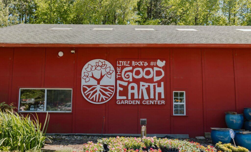 Red and white building sign for Good Earth Garden Center on red barn
