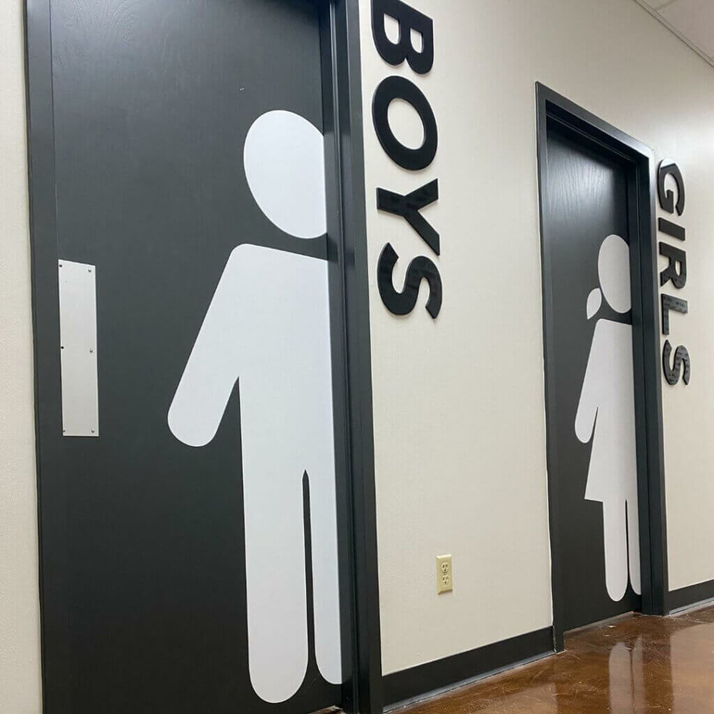 Directional bathroom signs and graphics