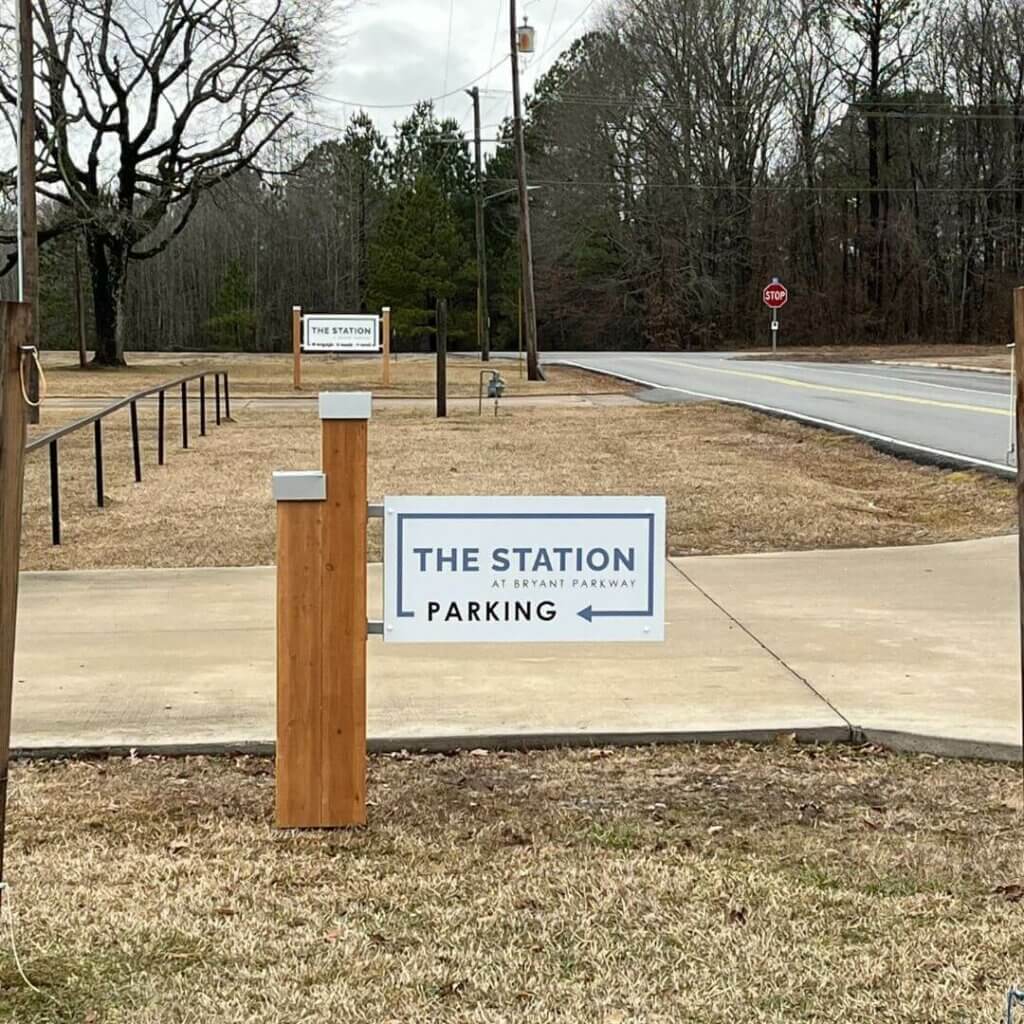 Exterior parking sign for "the station" with wood posts