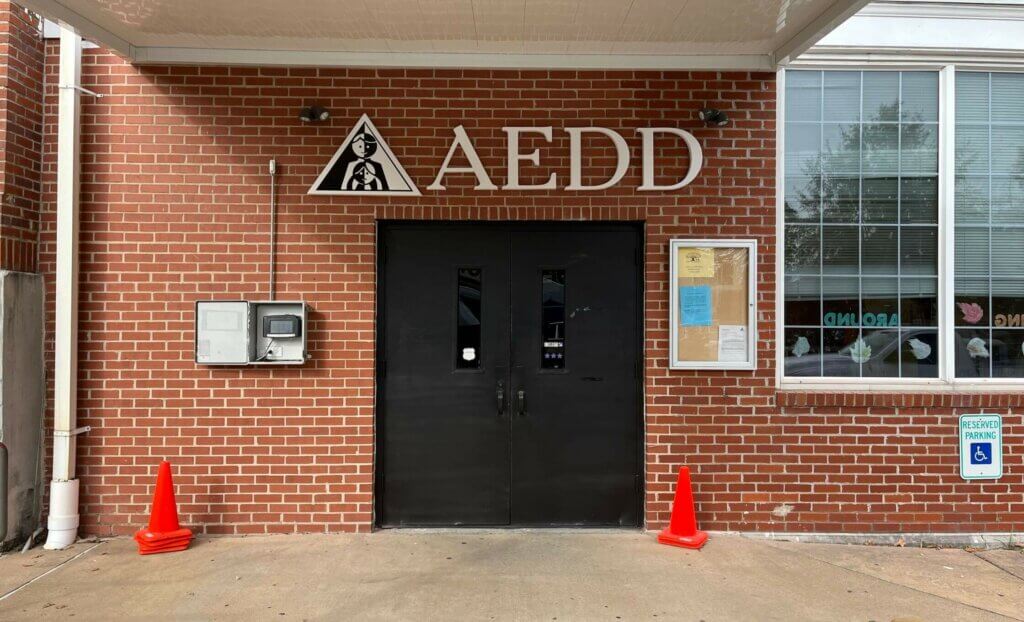 AEDD building sign on red brick exterior government building